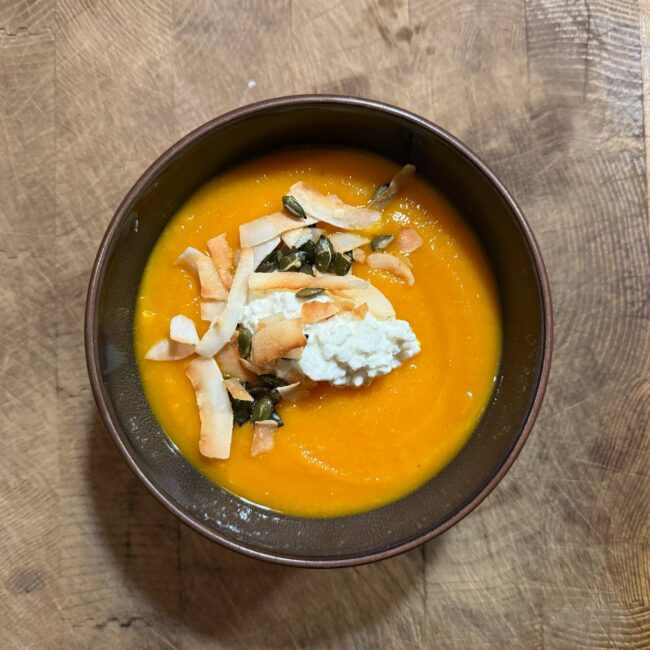 pompoensoep met toppings van bovenaf gefotografeerd